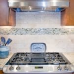 Custom Maple Cabinets, Limestone and glass backsplash, granite counters