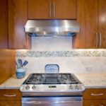 Custom Maple Cabinets, Limestone and glass backsplash, granite counters